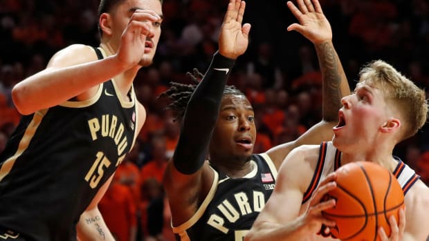 Purdue Boilermakers center Zach Edey (15) and Purdue Boilermakers guard Lance Jones (55) defend Illinois Fighting Illini forward Marcus Domask (3) during the NCAA men s basketball game, Tuesday, March 5, 2024, at State Farm Center in Champaign, Ill. Purdue Boilermakers won 77-71.